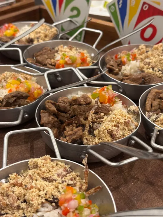 Mini panelas com carne em tiras, arroz, farofa e vinagrete para churrasco servido em festa